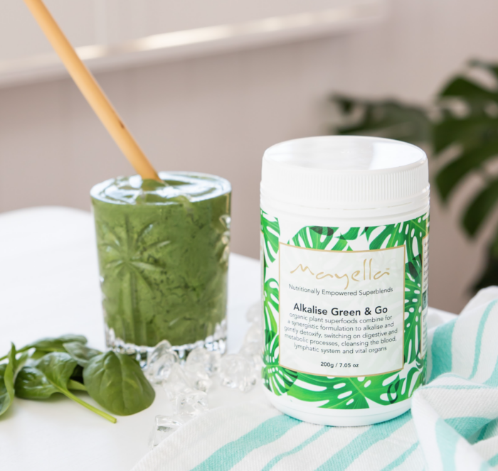 Mayella Alkalise Green & Go Blend next to a thick creamy Alkalise Green & Go Smoothie in a cut crystal glass.