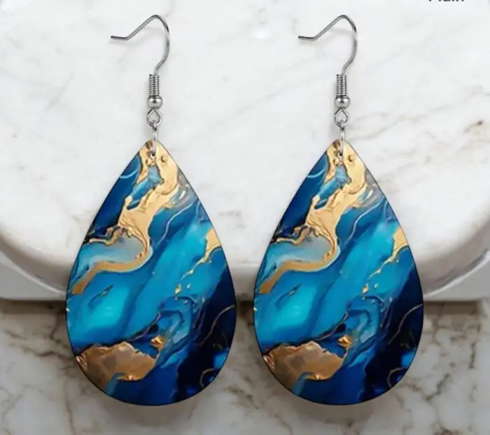 Elevate your style with these stunning blue and gold marble teardrop earrings, crafted from high-quality PU leather. Their unique design adds a touch of elegance to any outfit, making them perfect for both casual and formal occasions. Lightweight and comfortable, these earrings are a must-have accessory for anyone looking to make a statement.