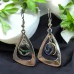 Crafted from durable stainless steel, these Silver Dangling earrings featuring a unique  abalone shell in bezel setting