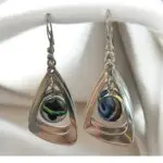 Crafted from durable stainless steel, these Silver Dangling earrings featuring a unique  abalone shell in bezel setting