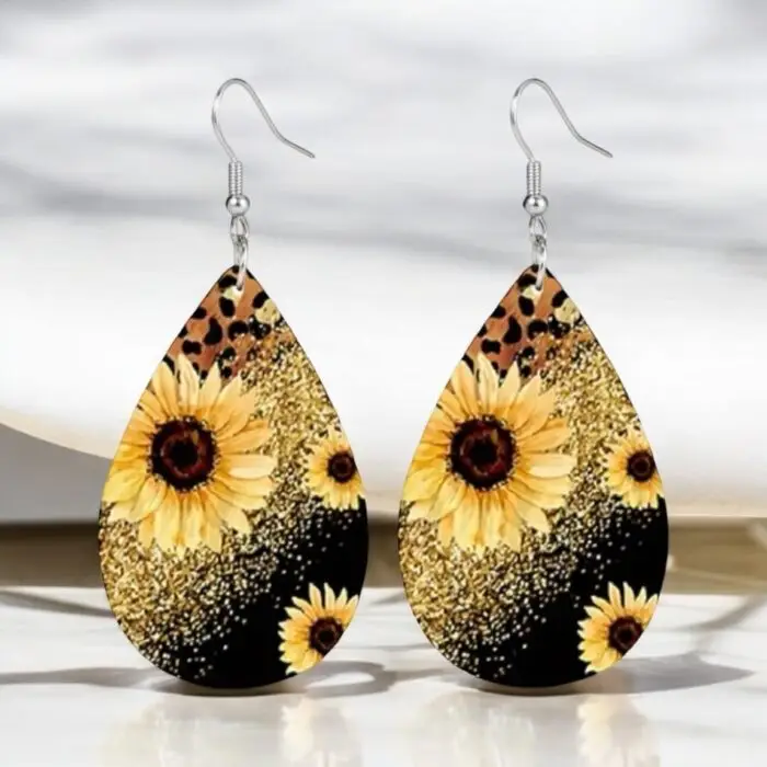 These sunflower printed earrings are a fun and stylish accessory that adds a pop of color and a touch of wild flair to any outfit. The vibrant sunflower design contrasts beautifully with the bold leopard and sparkly print, making them perfect for both casual and dressy occasions. Lightweight and easy to wear, these earrings are sure to turn heads and brighten your day!