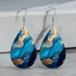 Elevate your style with these stunning blue and gold marble teardrop earrings, crafted from high-quality PU leather. Their unique design adds a touch of elegance to any outfit, making them perfect for both casual and formal occasions. Lightweight and comfortable, these earrings are a must-have accessory for anyone looking to make a statement.