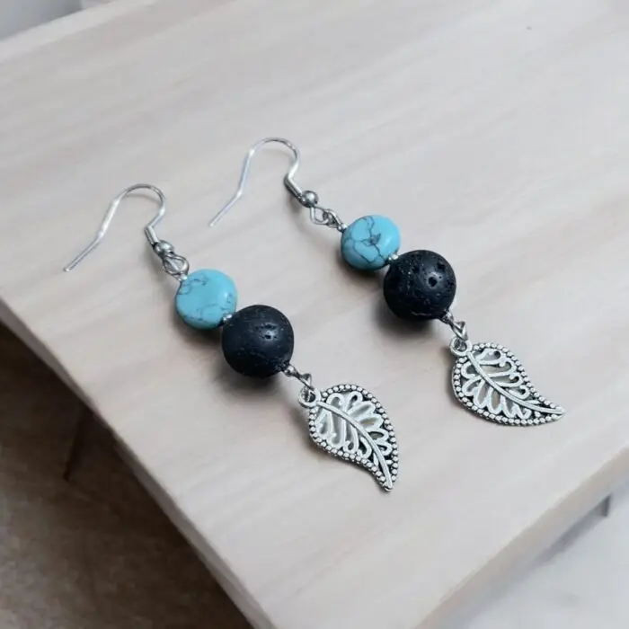 these stunning earrings featuring vibrant turquoise stones and unique lava rock accents. The delicate leaf design adds a touch of nature-inspired elegance, making them perfect for any occasion. Lightweight and comfortable, these earrings are a must-have accessory for those who love to stand out!