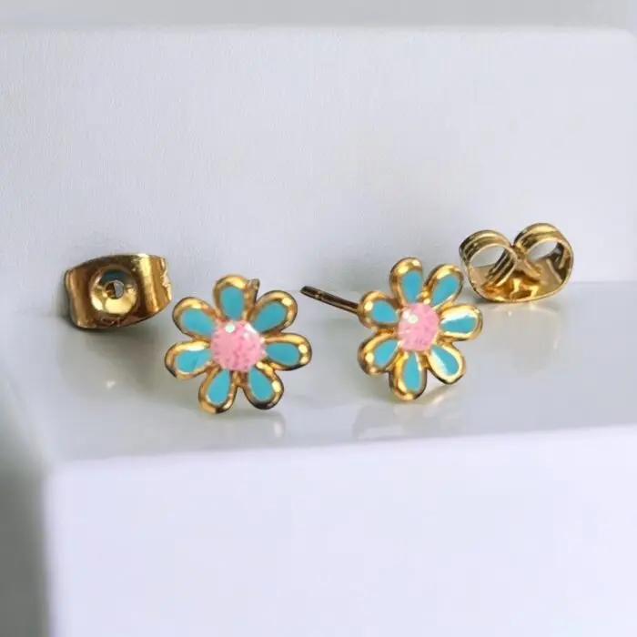 These adorable gold-plated enamel flower stud earrings are perfect for little girls who love to add a touch of charm to their outfits. With their vibrant colors and cute floral design, they’re not just accessories but a delightful way to express personality and style. Lightweight and comfortable, these earrings are ideal for everyday wear or special occasions, making them a must-have for any young fashionista.